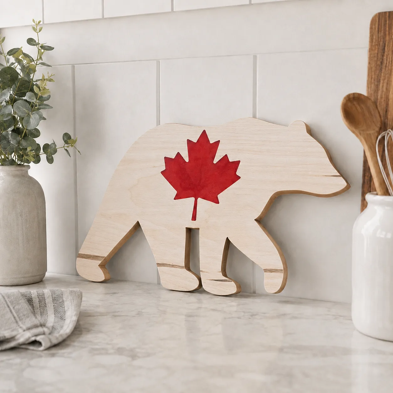 A Maple Bear with a red epoxy Maple Leaf Charcuterie Board